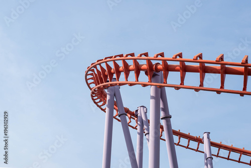 Roller coaster on blue sky background.