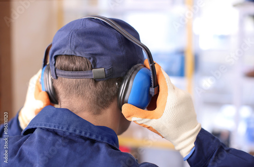 Schilderij op canvas Male worker with hearing protectors, indoors