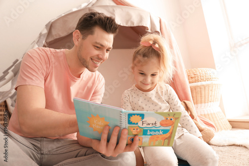 Father and his daughter rea...