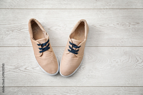 Casual male shoes on wooden floor