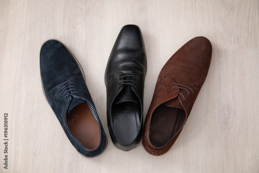 Different male shoes on wooden floor Different male shoes on wooden floor
