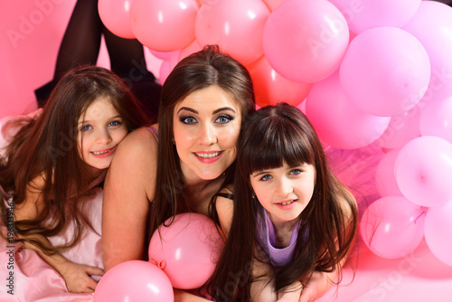 Little girls, mom in pink balloons.