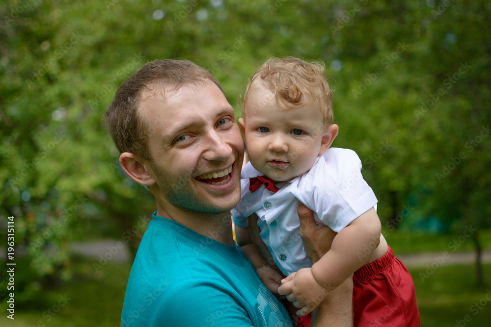 A smiling father with a small son. Portrait. Happy fatherhood A smiling father with a small son. Portrait. Happy fatherhood