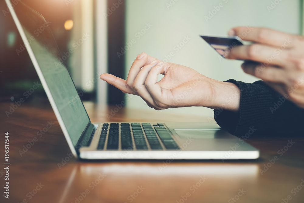 online payment and shopping, Young man using computer laptop and hand holding credit card for purchase to item on internet. online payment and shopping, Young man using computer laptop and hand holding credit card for purchase to item on internet.