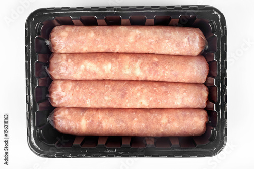 Package of raw sausages isolated on white background