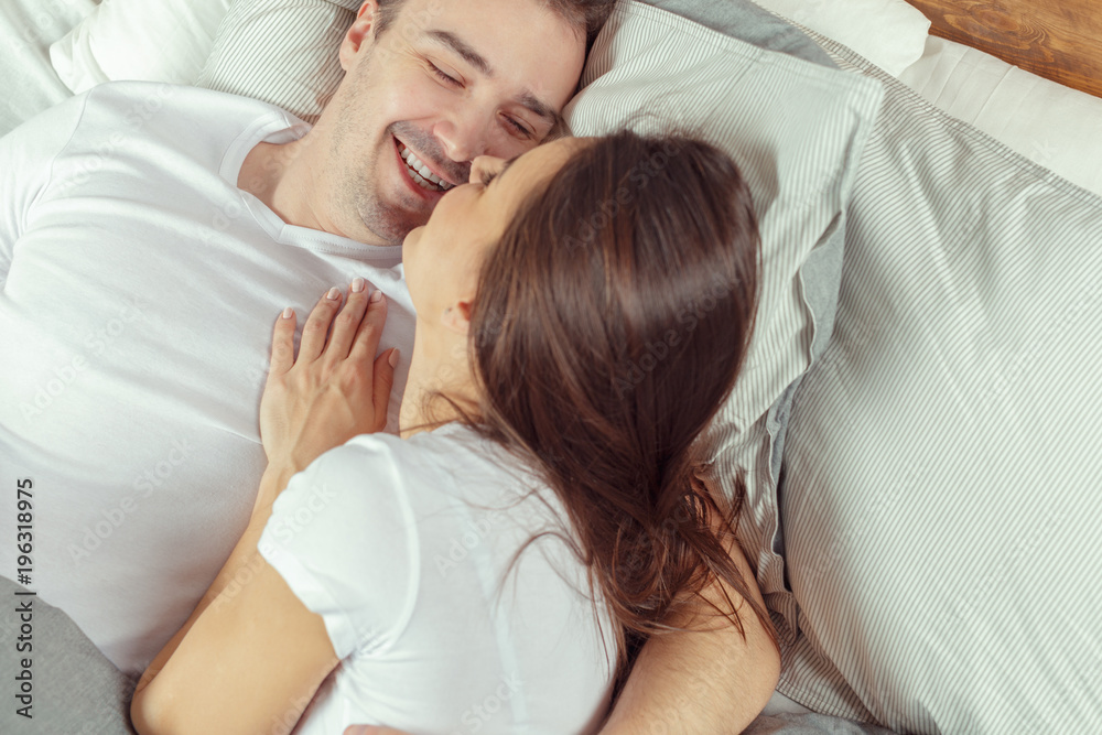 beautiful couple lying together on the bed beautiful couple lying together on the bed