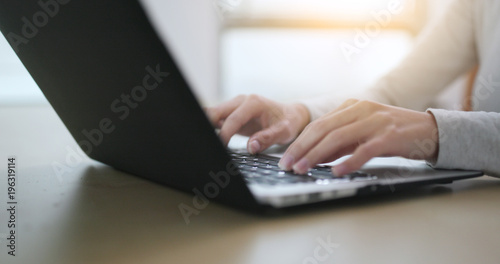Woman working on laptop computer at home