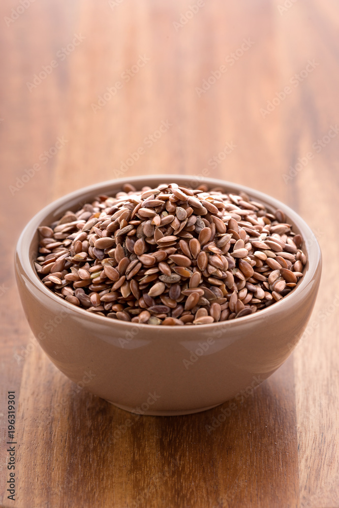 Flax seed in a bowl on a wooden background. Healthy vegetarian grain. Copy space Flax seed in a bowl on a wooden background. Healthy vegetarian grain. Copy space