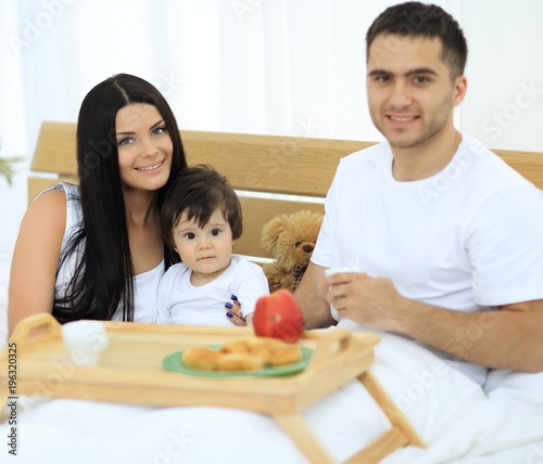 Family having breakfast in bed at home