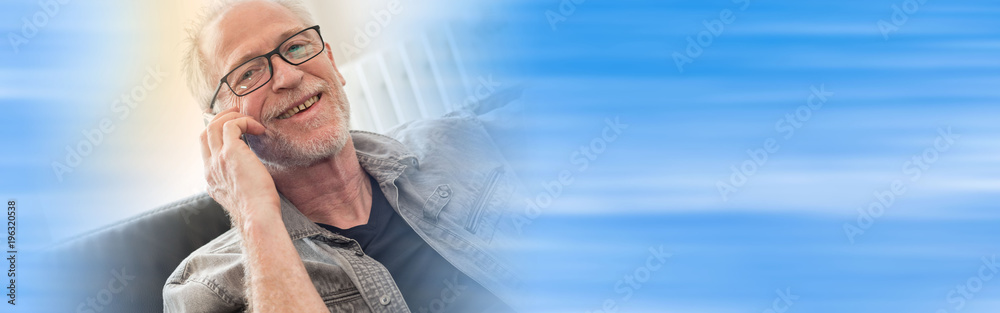 Obraz premium Portrait of smiling mature man talking on phone, light effect