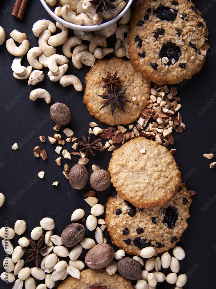 Oatmeal cookies, nuts and spices / Oatmeal cookies, nuts and spices on a dark background Oatmeal cookies, nuts and spices / Oatmeal cookies, nuts and spices on a dark background