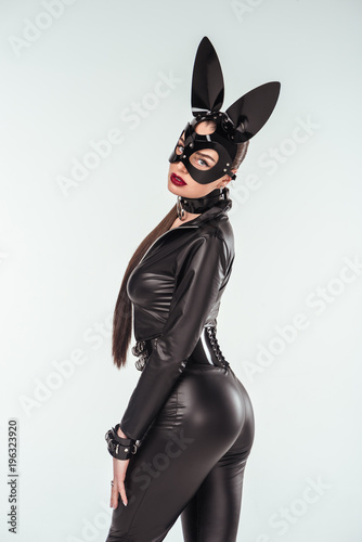 Kinky woman in sexy costume and mask with ears isolated on white © LIGHTFIELD STUDIOS