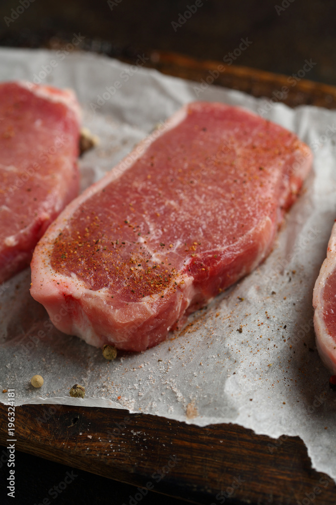 Uncooked fresh steaks on wood Uncooked fresh steaks on wood