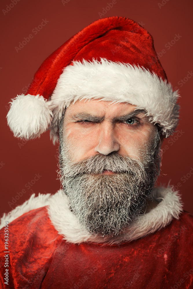 Santa Claus with serious face and frozen beard. Christmas, new year,  winter, snow concept - Christmas man in Santa Claus costume on red  background. New year, holiday, celebration. Stock Photo | Adobe Stock