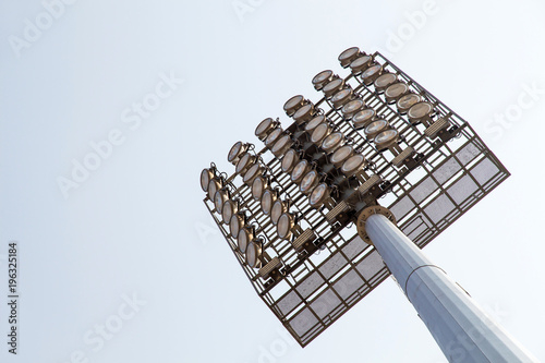 giant spotlights are in the stadium to the high pole with sky background photo