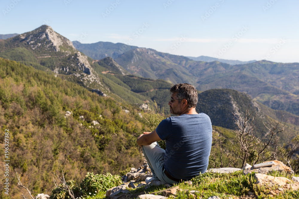 Traveller man looking at mountain landscape
