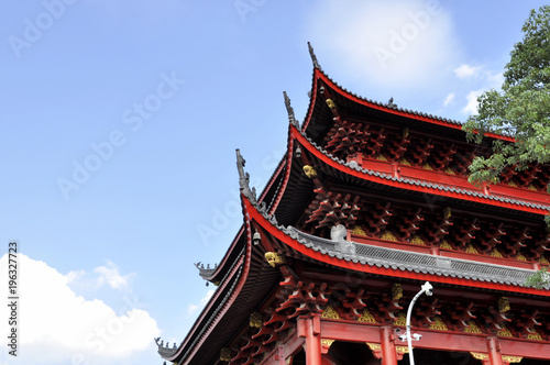 Chinese style temple roof against blue sky background
