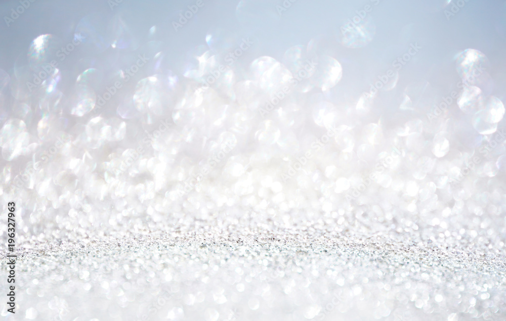 Glitter background in pastel delicate silver light blue and white tones de-focused. Glitter background in pastel delicate silver light blue and white tones de-focused.