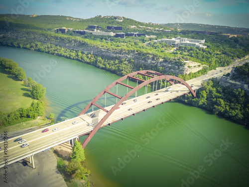Vintage tone aerial view Pennybacker Bridge or 360 Bridge with car traffic at daytime. It is a landmark in Austin, Texas, USA. Top of Town Lake, Colorado River and Hill Country green landscape