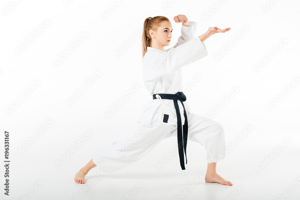 girl in kimono training karate isolated on white girl in kimono training karate isolated on white