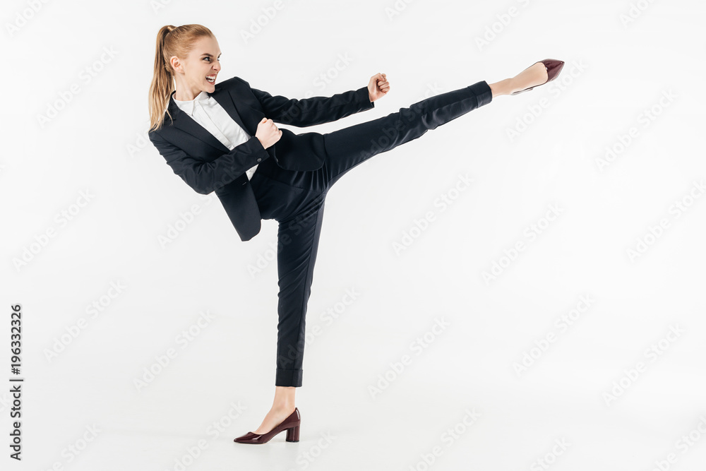 businesswoman performing karate kick in suit and high heels isolated on  white Stock-Foto | Adobe Stock