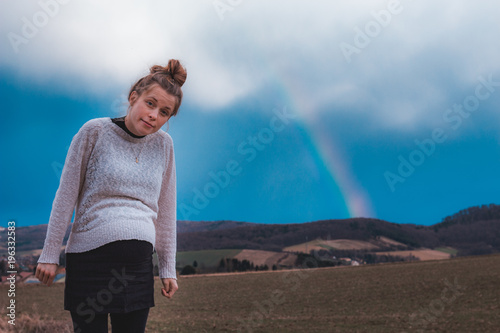 beautiful pregnant woman and a rainbow outdoors in nature © Alexander