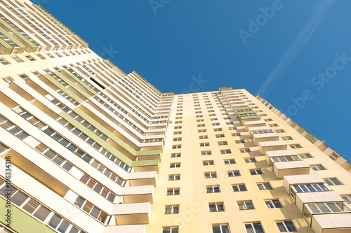 High-rise apartment building against the blue sky