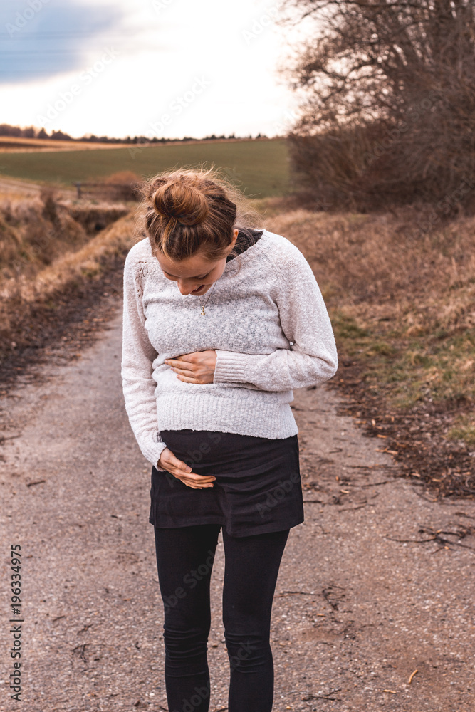 young pregnant woman outdoors in rural landscape young pregnant woman outdoors in rural landscape