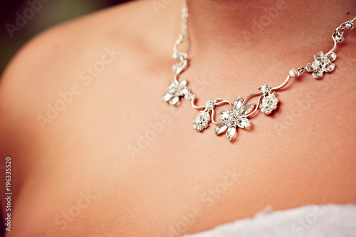 Detail of a wedding necklace on a bride photo
