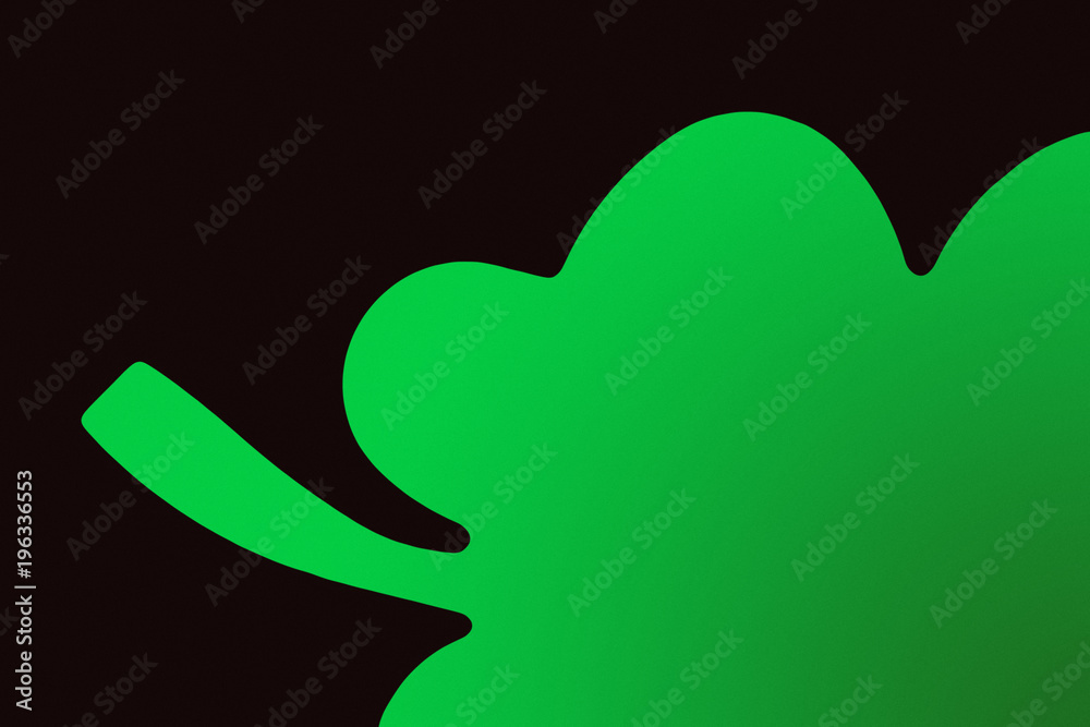 close-up view of green shamrock symbol isolated on black close-up view of green shamrock symbol isolated on black
