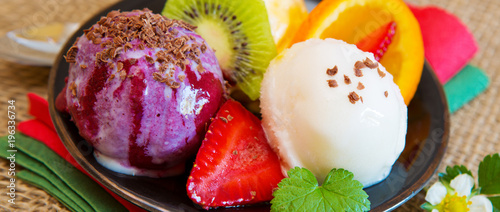 Mixed fruit ice cream with strawberry .