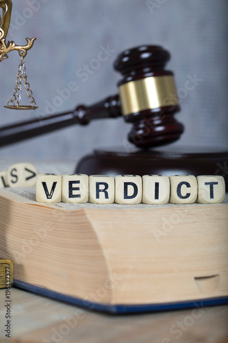 Word VERDICT composed of wooden letters.