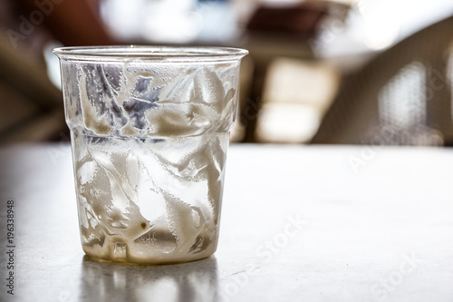 cocktail glass or empty drink is used with drops of foam on a table