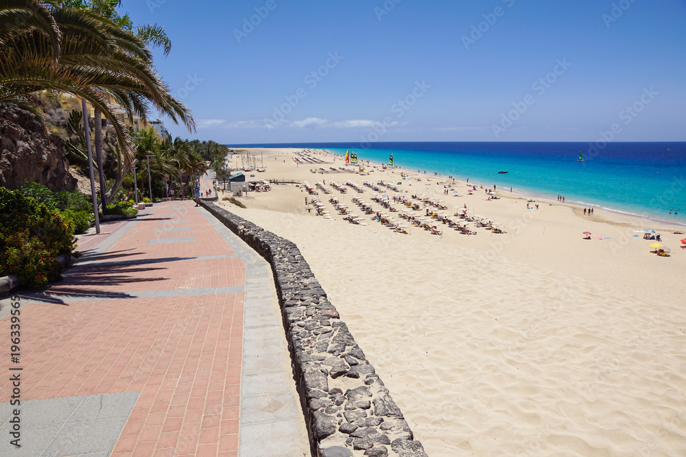 Sand dune and coastal promenade along a beach in Morro Jable town, Fuerteventura, Canary Islands, Spain