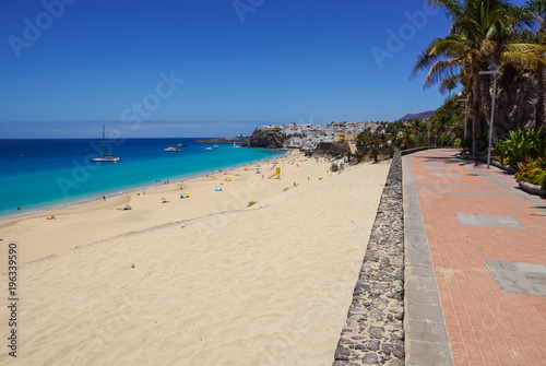 Promenade with tropical plants and flowers along a beach in Morro Jable holiday village  Fuerteventura  Canary Islands  Spain