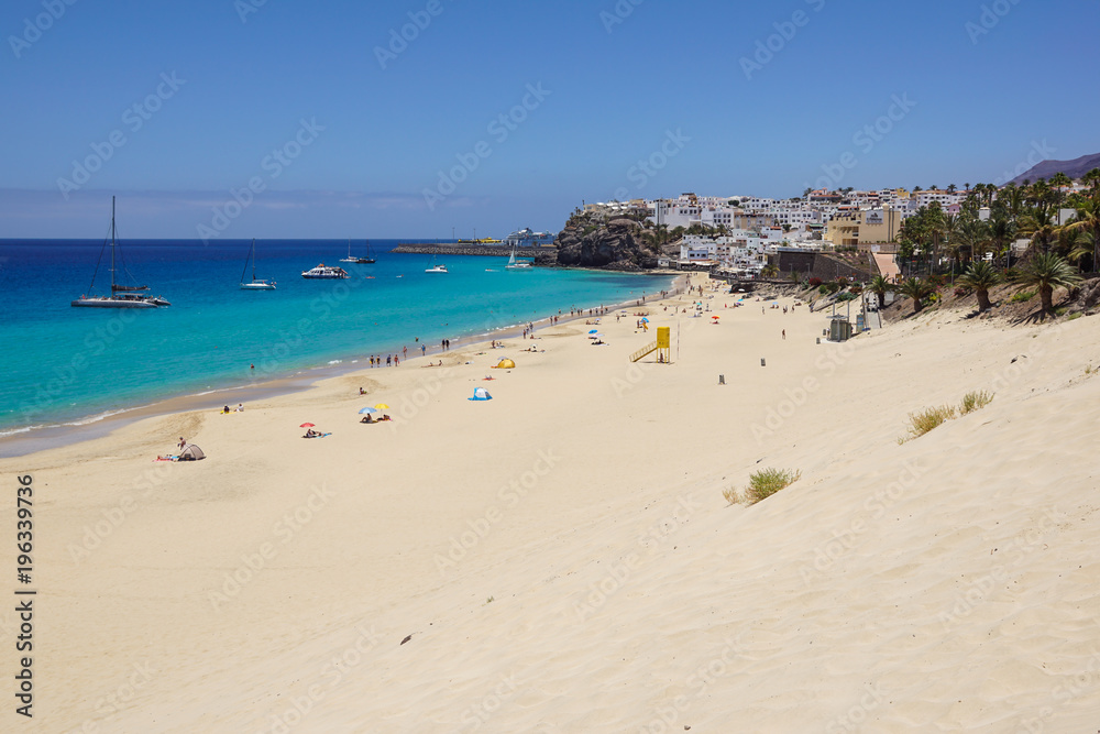 Sand dune and coastal promenade along a beach in Morro Jable town, Fuerteventura, Canary Islands, Spain