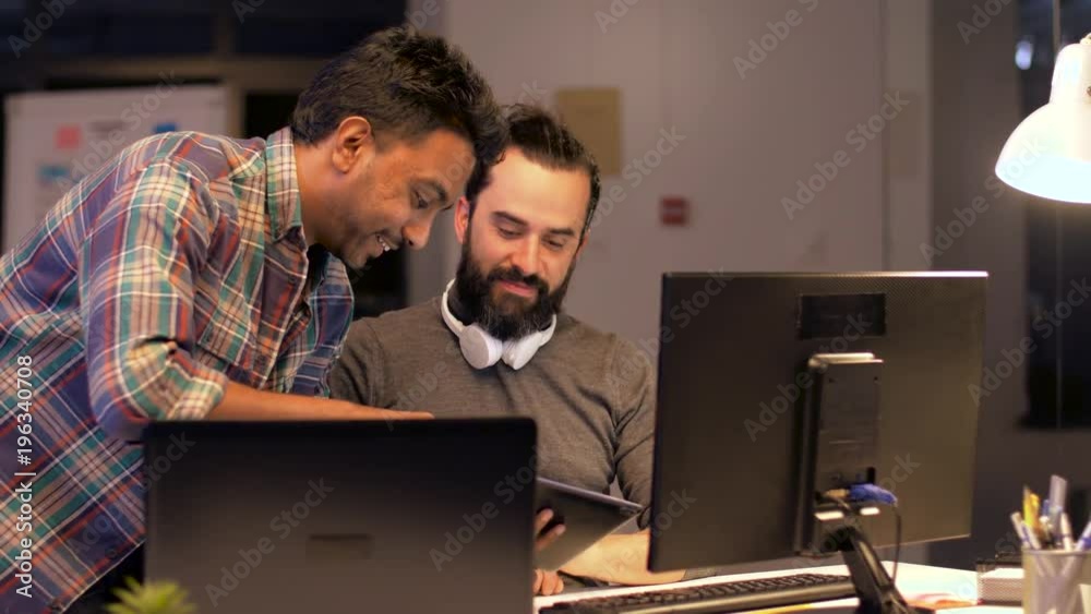 creative team with computers works at night office creative team with computers works at night office