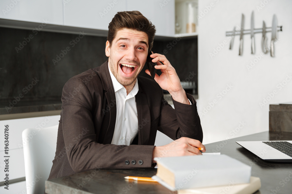 Shocked young businessman working talking by mobile phone. Shocked young businessman working talking by mobile phone.