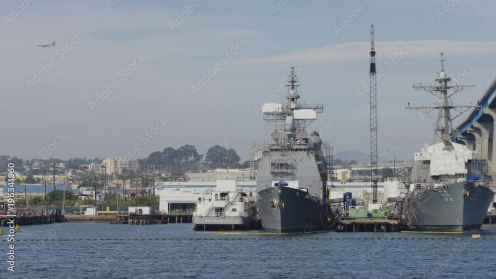 Navy ships anchored near a bridge