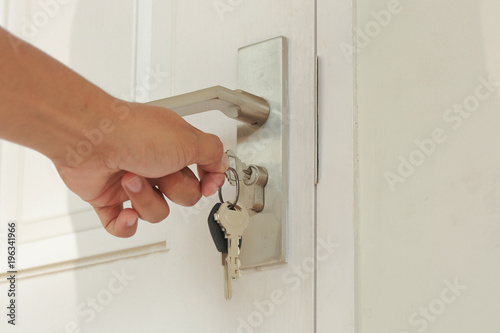 Canvas-taulu Hand use the key for unlocking and open the white door
