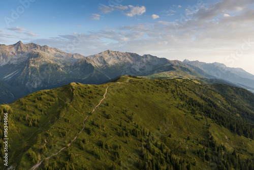 aerial image of green meadows in a mountain landscape at Isère