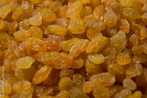White raisins background - healthy vegan food. Macro photo
