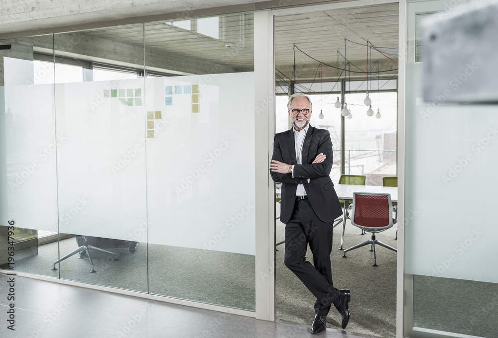 Portrait of confident mature businessman standing in office Portrait of confident mature businessman standing in office