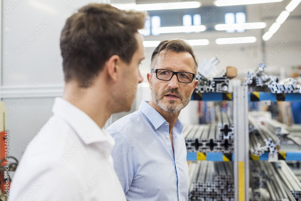 Two businessmen discussing in factory Two businessmen discussing in factory