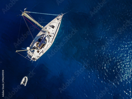 Top view of the white yacht in the exotic turquoise sea.