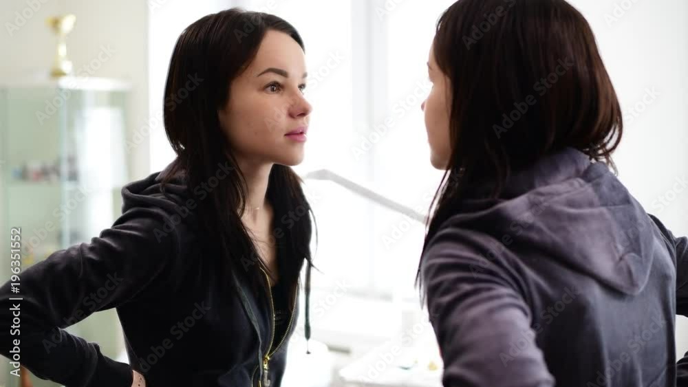young beautiful girl looks at herself in mirror young beautiful girl looks at herself in mirror