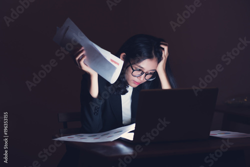 Exhausted and tired worker surrendering to fatigue working with laptop at office. Businesswoman making mistake about financial business at late night work . Overworking concept