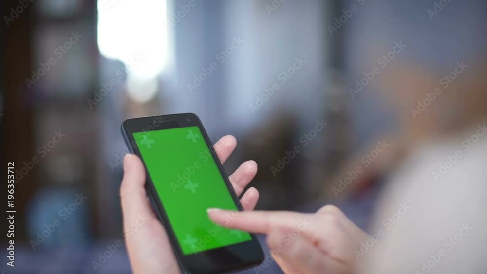 woman using a Smartphone with green screen woman using a Smartphone with green screen
