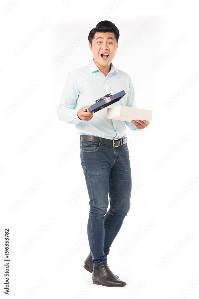 Studio portrait of young Asian man holding gift box Studio portrait of young Asian man holding gift box