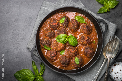 Meatballs in tomato sauce on a black background. 